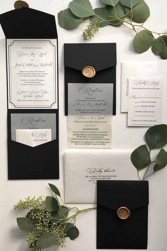 a laconic black and white wedding invitation suite with pocket-style black envelopes, white and vellum invitations with calligraphy