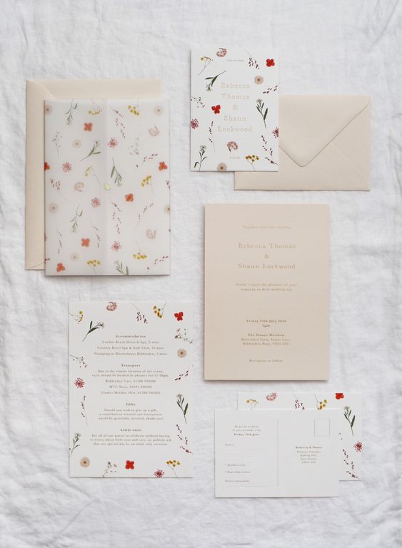 a lively summer wedding invitation suit in neutrals, with floral usual and vellum invites and beautiful beige envelopes