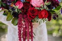 a lovely wedding bouquet with pink, deep red, burgundy, purple and blue blooms, lisianthus and foliage is amazing for the fall