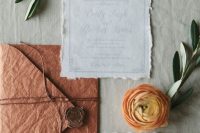 a neutral and rust-colored handmade wedding invitation suite with seals and twine is a great idea for a fall wedding