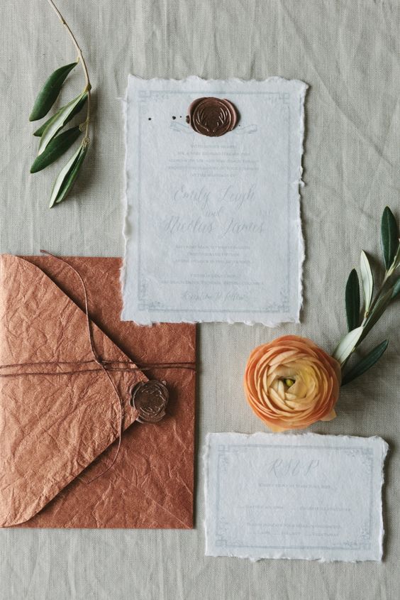 a neutral and rust colored handmade wedding invitation suite with seals and twine is a great idea for a fall wedding