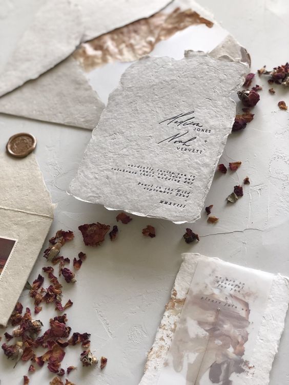 a neutral wedding invitation suite of handmade paper, torn edge and some vellum touches is a lovely idea