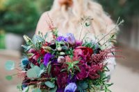 a statement jewel tone wedding bouquet with deep purple, burgundy, violet blooms, thistles and greenery for a bold wedding