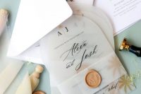 a stylish modern wedding invitation suite with a white envelope, arched vellum invites with a gold seal is amazing