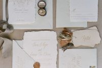 a subtle and delicate wedding invitation suite in light green and neutrals, with gold calligraphy and botanical prints, pretty seals