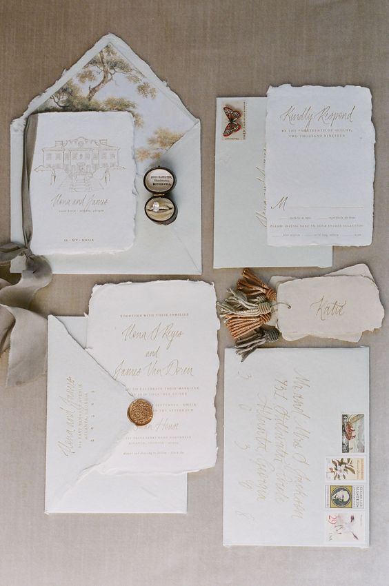 a subtle and delicate wedding invitation suite in light green and neutrals, with gold calligraphy and botanical prints, pretty seals
