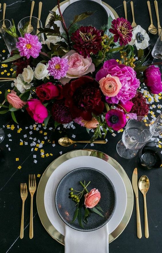 a super bright wedding centerpiece of hot pink, blush, burgundy and deep purple blooms and a bit of berries for the fall
