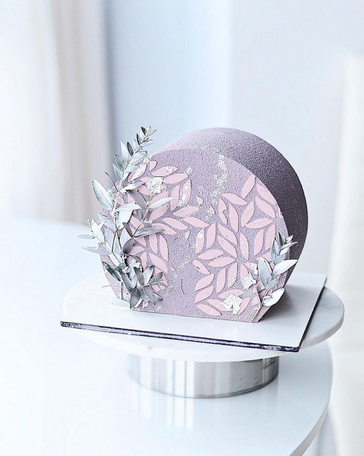 a wintry textured top forward wedding cake decorated with blue dried grasses and pink petals is a gorgeous idea to go for