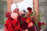 an extra bold wedding bouquet including burgundy, deep red, blush and deep purple blooms and greenery for the fall