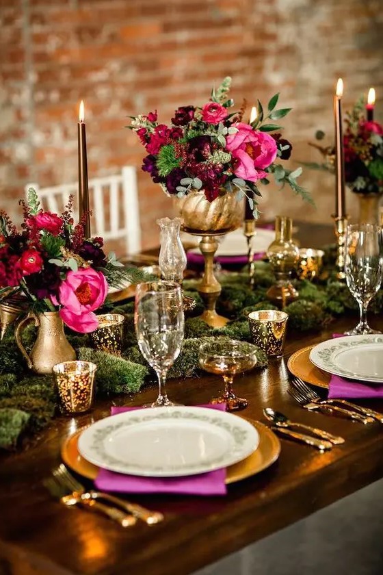 burgundy and hot pink centerpieces in gold vases create lush decor and make it jaw-dropping
