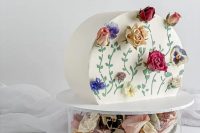featuring dried roses, pansies and chrysanthemum in soft buttercream icing, this piece would be perfect for a fairytale themed wedding