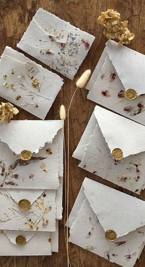 handmade paper wedding envelopes with pressed blooms and gold seals are amazing for a summer wildflower wedding