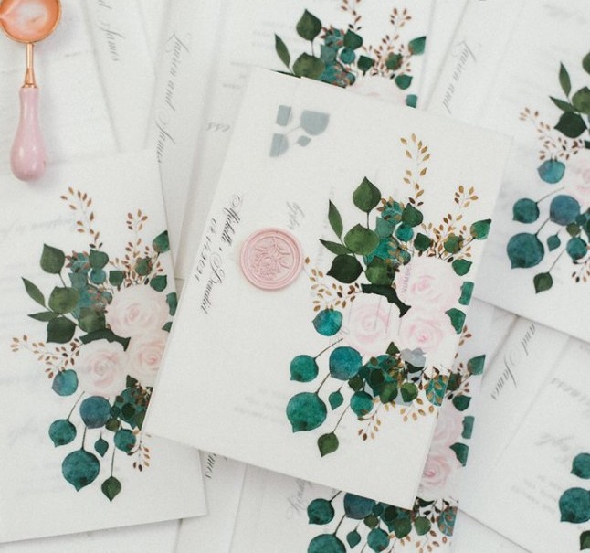 wedding invitations placed into floral vellum jackets and with elegant pink seals are amazing for a delicate spring or summer wedding