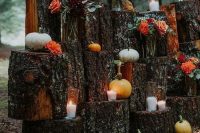 15 a rustic fall wedding altar made of tree stumps, candles, bold blooms, various mini pumpkins is a cool solution to rock