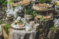 19 a gorgeous woodland wedding sweets table styled with lots of stumps and wood slices, moss, greenery and succulents and featuring delicious pies and mini pies