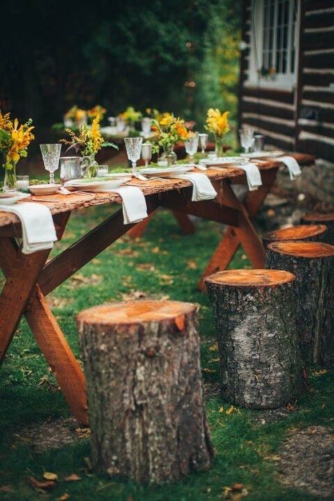 a rustic wedding tablescape with a living edge table and tree stumps as stools, bright blooms and neutral linens can be composed by you yourself