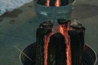 38 burning tree stumps in galvanized tubs are gorgeous wedding lights and decoration for a fall or winter wedding, you can DIY it