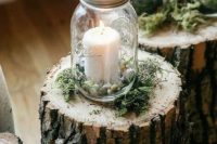 46 tree stumps topped with moss, candle lanterns with pebbles are a great idea for a woodland or rustic wedding