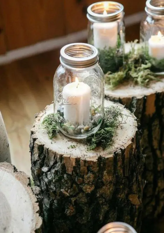 tree stumps topped with moss, candle lanterns with pebbles are a great idea for a woodland or rustic wedding