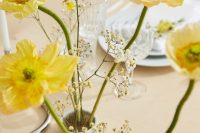 a beautiful ikebana style wedding centerpiece of yellow poppies and some additional fillers is a lovely idea for spring or summer