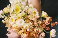 a beautiful ombre wedding bouquet from white to yellow, coffee-colored and dusty pink blooms including roses and poppies