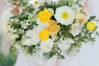 a bold wedding bouquet of white and yellow poppies, ranunculus and peonies, greenery and bouquet fillers plus long ribbon