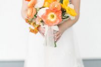a bright red, orange and yellow poppy wedding bouquets with greenery and some neutral ribbon is amazing as a color accent