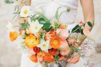 a catchy wedding bouquet of pink peony roses, white, yellow and red poppies and some greenery is a cool idea for summer