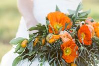 a colorful wedding bouquet of orange poppies and ranunculus, greenery and citrus is amazing for a summer wedding