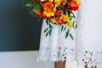 a colorful wedding bouquet of orange, yellow poppies, red tulips and greenery is a lovely idea for a summer wedding