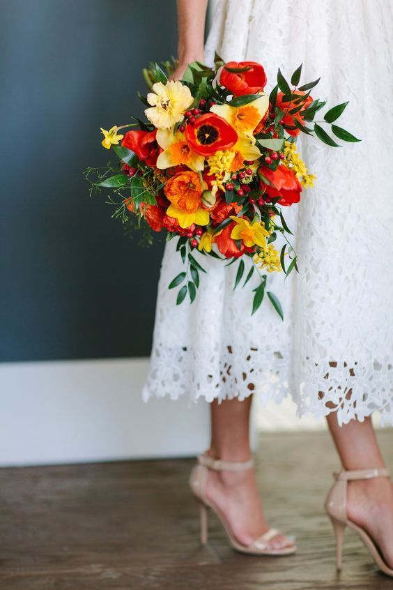 a colorful wedding bouquet of orange, yellow poppies, red tulips and greenery is a lovely idea for a summer wedding