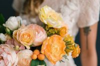 a muted color wedding bouquet of peachy, blush and yellow peonies and poppies and some citrus is amazing