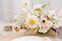 a neutral wedding centerpiece of white and blush blooms is a lovely idea for a spring or summer wedding in neutrals