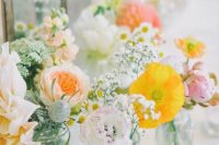 a pastel cluster wedding centerpiece of yellow poppies, blush and white dahlias, peony roses and baby’s breath is chic