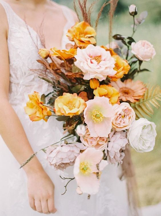an amber wedding bouquet of amber and light pink poppies and some other blooms, twigs and grasses is a great solution for the fall