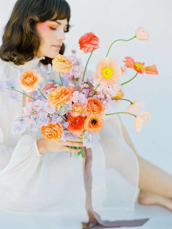 an artful wedding bouquet of lilac and peachy blooms, some muted color poppies is an amazing idea for a spring bride