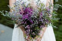 02 a textural and bold wedding bouquet of purple dahlias, waxflower and lots of simple grasses and wildflowers is amazing for a summer wedding