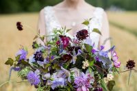 06 a bold and catchy wedding bouquet with deep burgundy, lilac and pale lilac blooms and greenery is amazing for fall or summer