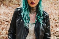 06 a rock bridal outfit with an A-line wedding dress with an embellished bodice, a black leather jacket, green hair, a celestial tiara and bold tattoos shown off