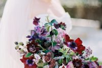 07 a bold wedding bouquet with purple and deep purple blooms, burgundy and red ones, berries, thistles and pale blue ribbon for a fall wedding