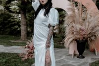 07 a rock n roll wedding dress with sparkles, a thigh high slit, puff sleeves, dusty pink shoes to show off the bride’s tattoos