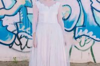 12 a badass bridal look with anA-line midi wedding dress and sheer sleeves, grey rocks, irridescent shoes and purple to pink hair