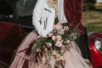 16 a glam rock bridal look with a corset, a blush tutu skirt with a burgundy train, a white leather jacket and black lace high boots