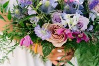 18 a gorgeous purple wedding bouquet with lilac roses, thistles, purple freesias, lisianthus and greenery cascading