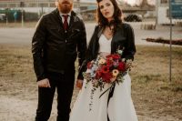 19 a modern rock n roll bridal look with a crop top and a full skirt with a train, a black leather jacket, a bold hairstyle and a red lip plus a bright bouquet