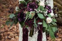 21 a moody deep purple wedding bouquet with lisianthus, berries, greenery and white blooms is a lovely idea for a fall wedding