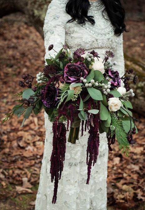 a moody deep purple wedding bouquet with lisianthus, berries, greenery and white blooms is a lovely idea for a fall wedding