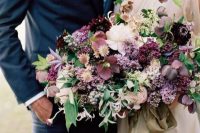22 a moody wedding bouquet with purple, pink and neutral blooms, greenery and some berries for a fall or summer wedding