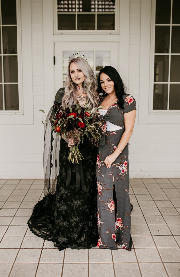 a romantic rock n roll bridal look wiht a black lace off the shoulder wedding dress, a cool tiara, a black veil, multiple piercings and grey hair