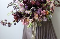 26 a refined moody wedding bouquet with deep purple, pink, mauve blooms and a bit of greenery for a fall bride